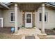 Inviting front porch with stone accents, decorative lighting, and a welcoming 