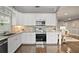 Well-lit kitchen with stainless steel appliances, light granite countertops, and a seamless view to the living room at 1684 Braeburn Se Dr, Atlanta, GA 30316