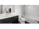 Bathroom featuring marble tiling, chrome fixtures, and tub shower combination at 343 Concord St, Alpharetta, GA 30009