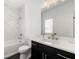Bathroom featuring a tub and shower combination, marble tiling, and modern vanity at 343 Concord St, Alpharetta, GA 30009
