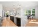 Bright kitchen with an island, stainless steel appliances, hardwood floors, and an adjacent dining area at 343 Concord St, Alpharetta, GA 30009