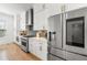 Updated kitchen featuring white cabinets, stainless steel appliances, and a tiled backsplash at 343 Concord St, Alpharetta, GA 30009