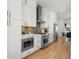 Modern kitchen with white cabinets, stainless steel appliances, and hardwood flooring at 343 Concord St, Alpharetta, GA 30009