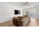Open living room with a large sofa, TV, and access to the screened in outdoor space at 343 Concord St, Alpharetta, GA 30009
