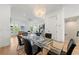 Open-concept space features a dining area and living area, connected by light wood floors and elegant decor at 343 Concord St, Alpharetta, GA 30009