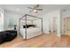 Spacious main bedroom with a four-poster bed, ceiling fan, and wood flooring at 343 Concord St, Alpharetta, GA 30009