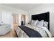 Main bedroom featuring a padded headboard, hardwood floors, and a sitting chair at 343 Concord St, Alpharetta, GA 30009
