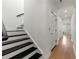 Stairway with white walls, black painted steps, and natural wood flooring at 343 Concord St, Alpharetta, GA 30009