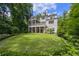 Expansive backyard with lush lawn, screened porch and elegant architecture at 803 Courtenay Ne Dr, Atlanta, GA 30306