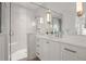 Bright white bathroom features dual vanities and a glass-enclosed shower with a built-in seat at 803 Courtenay Ne Dr, Atlanta, GA 30306