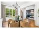 Dining room with modern lighting, large windows, and an open view to a stylish sitting room at 803 Courtenay Ne Dr, Atlanta, GA 30306