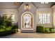 Inviting front entrance featuring an arched doorway and manicured landscaping at 803 Courtenay Ne Dr, Atlanta, GA 30306