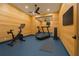 Modern gym with wood paneling, including a bike, treadmill, weights, and mounted flat screen TV at 803 Courtenay Ne Dr, Atlanta, GA 30306