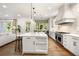 Spacious open concept kitchen with large island, stainless steel appliances and breakfast nook with built-in seating at 803 Courtenay Ne Dr, Atlanta, GA 30306