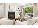 Bright living room with fireplace and access to the outdoor deck through glass doors at 803 Courtenay Ne Dr, Atlanta, GA 30306