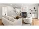Bright living room with fireplace and staircase, featuring hardwood floors and white walls at 803 Courtenay Ne Dr, Atlanta, GA 30306