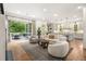 Bright and airy living room open to the kitchen featuring hardwood floors and access to the outdoor deck at 803 Courtenay Ne Dr, Atlanta, GA 30306