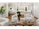 Cozy living room open to the kitchen with hardwood floors, modern lighting, and comfortable furnishings at 803 Courtenay Ne Dr, Atlanta, GA 30306