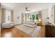 Bright main bedroom featuring hardwood floors, large windows, and elegant decor, creating a serene and inviting atmosphere at 803 Courtenay Ne Dr, Atlanta, GA 30306