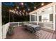 Inviting screened porch featuring a dining table, string lights, and a cozy fireplace at 803 Courtenay Ne Dr, Atlanta, GA 30306