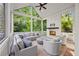 Inviting screened porch featuring a cozy fireplace, vaulted ceilings, and comfortable seating for relaxing or entertaining guests at 803 Courtenay Ne Dr, Atlanta, GA 30306
