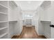 Large walk-in closet with custom shelving, hardwood floors, and tons of storage space at 803 Courtenay Ne Dr, Atlanta, GA 30306