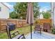 Private backyard featuring a patio, table umbrella, well-maintained lawn, and wooden fence at 113 Regent Pl, Woodstock, GA 30188