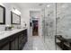 Sleek bathroom with dual sink vanity, and an adjacent glass enclosed shower with bench at 113 Regent Pl, Woodstock, GA 30188