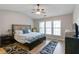 Comfortable bedroom boasting a large window, ceiling fan and contemporary decor at 113 Regent Pl, Woodstock, GA 30188