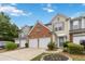 Townhouse with brick and siding, well-manicured lawn, and a two-car garage at 113 Regent Pl, Woodstock, GA 30188