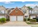 Charming townhome featuring a two-car garage and well-maintained landscaping at 113 Regent Pl, Woodstock, GA 30188