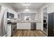 Updated kitchen with granite countertops and stainless steel appliances overlooking dining at 113 Regent Pl, Woodstock, GA 30188