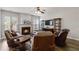 Cozy living room with a fireplace, hardwood floors, and lots of natural light at 113 Regent Pl, Woodstock, GA 30188