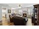 Open-concept living room featuring hardwood floors and access to kitchen and dining at 113 Regent Pl, Woodstock, GA 30188