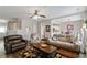 Bright and airy living room with hardwood floors open to dining and stairs at 113 Regent Pl, Woodstock, GA 30188