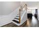 Elegant staircase with decorative molding and hardwood floors at 113 Regent Pl, Woodstock, GA 30188