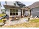 Beautiful backyard featuring a stone patio, outdoor dining area, and covered seating, perfect for entertaining at 1753 Russell Se St, Atlanta, GA 30316
