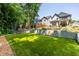 A level backyard with artificial turf, basketball court, retaining wall, and patio, perfect for outdoor entertaining at 1753 Russell Se St, Atlanta, GA 30316