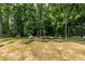 Picturesque backyard with mature trees, a swing set, and well-manicured landscaping, offering a private retreat at 1753 Russell Se St, Atlanta, GA 30316