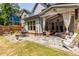 Spacious backyard patio with stone flooring, covered seating area, and lush green lawn, ideal for outdoor living at 1753 Russell Se St, Atlanta, GA 30316