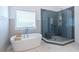 Relaxing bathroom with a soaking tub and a separate glass-enclosed shower at 1753 Russell Se St, Atlanta, GA 30316