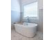 Bright bathroom featuring a soaking tub next to the window at 1753 Russell Se St, Atlanta, GA 30316