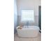 Soaking tub and window with paneled walls in bright and airy bathroom at 1753 Russell Se St, Atlanta, GA 30316