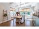 Dining room features an elegant chandelier, coffered ceilings, and natural light from the large windows and glass doors at 1753 Russell Se St, Atlanta, GA 30316