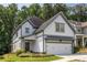 Charming two-story home featuring white siding, gray trim, a two-car garage, and a beautifully landscaped front yard at 1753 Russell Se St, Atlanta, GA 30316