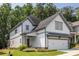 Beautiful two-story home showcases white siding, gray trim, a two-car garage, and an inviting landscaped front yard at 1753 Russell Se St, Atlanta, GA 30316