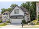 Attractive two-story home displays white siding, gray trim, a two-car garage, and well-maintained landscaping at 1753 Russell Se St, Atlanta, GA 30316