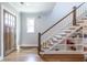 Entryway featuring hardwood floors, a staircase with built-in shelves, and a stylish wooden front door at 1753 Russell Se St, Atlanta, GA 30316