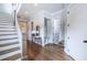 Bright foyer featuring hardwood floors, a staircase, a coat nook, and white paneled doors at 1753 Russell Se St, Atlanta, GA 30316