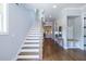 Elegant foyer with hardwood floors, a staircase, and a convenient coat nook with bench seating at 1753 Russell Se St, Atlanta, GA 30316